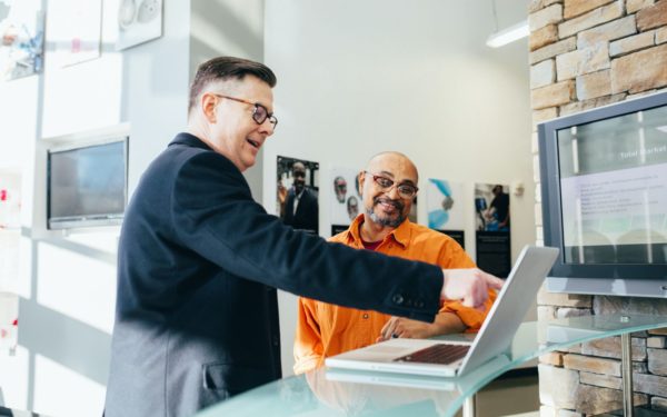 man-in-suit-pointing-at-computer-screen