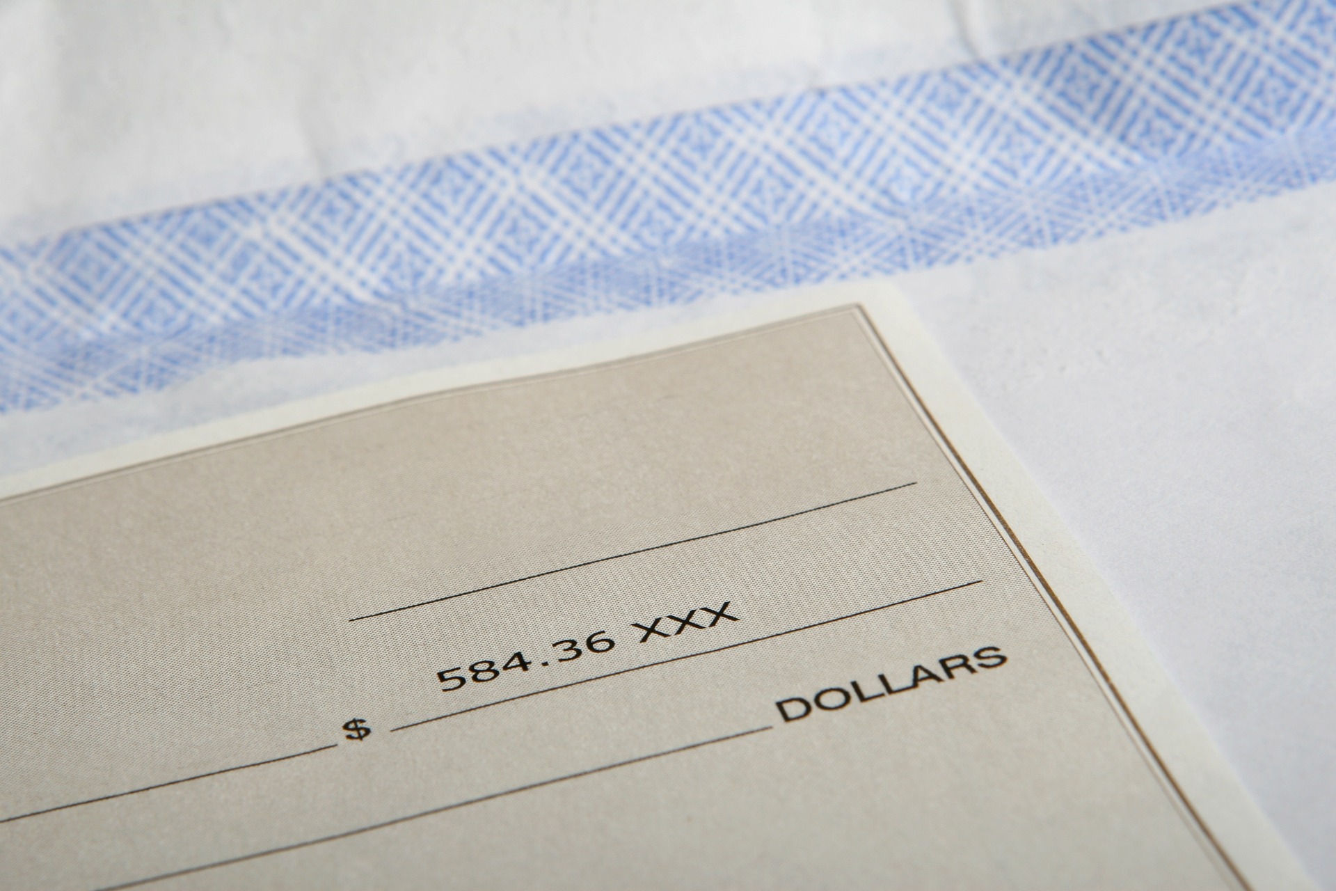 upclose-picture-of-a-paycheck-and-envelope