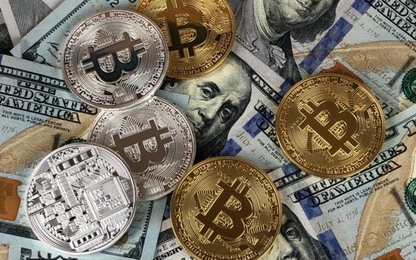 various-cryptocurrency-coins-laying-on-top-of-cash