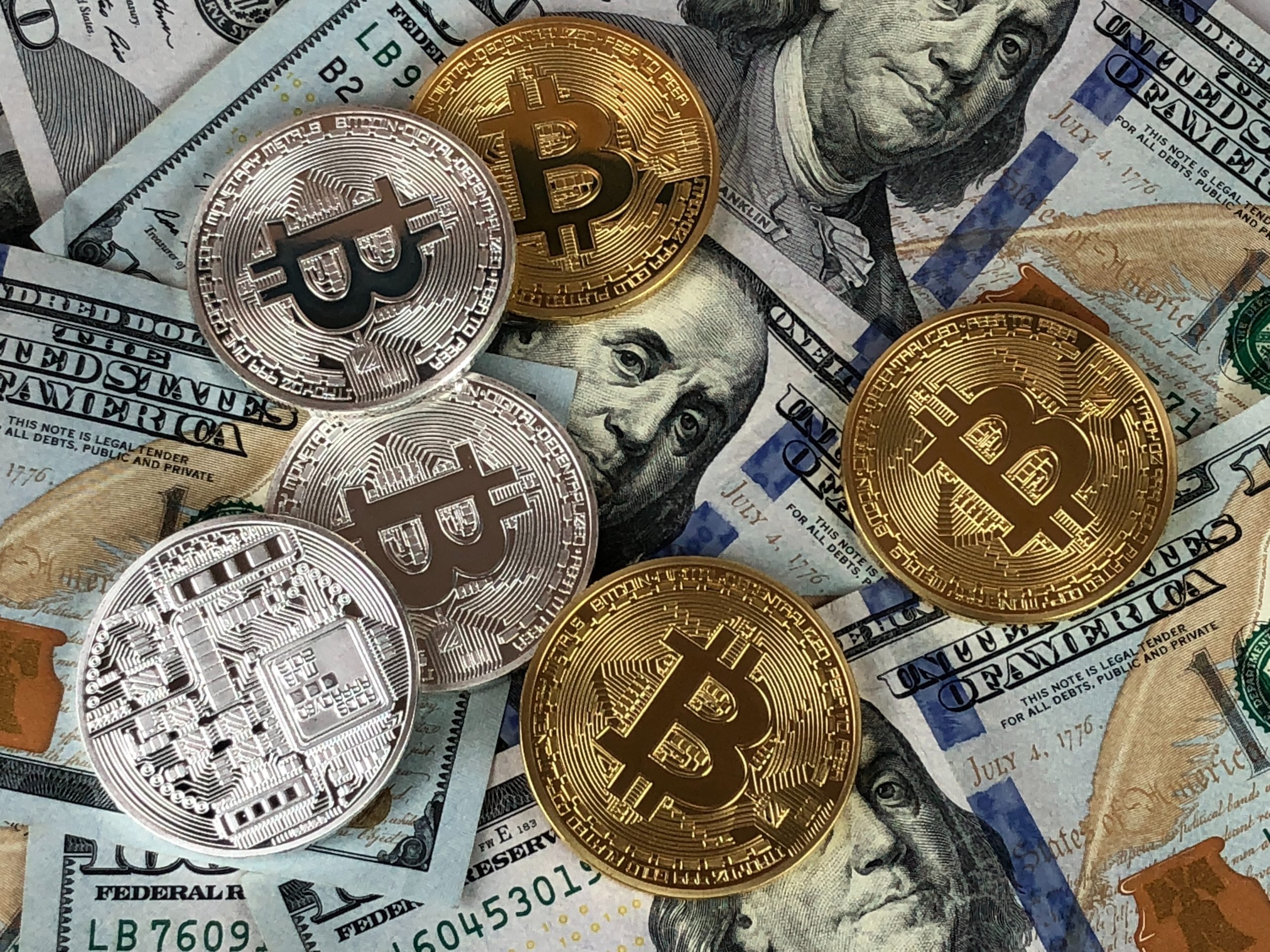 various-cryptocurrency-coins-laying-on-top-of-cash