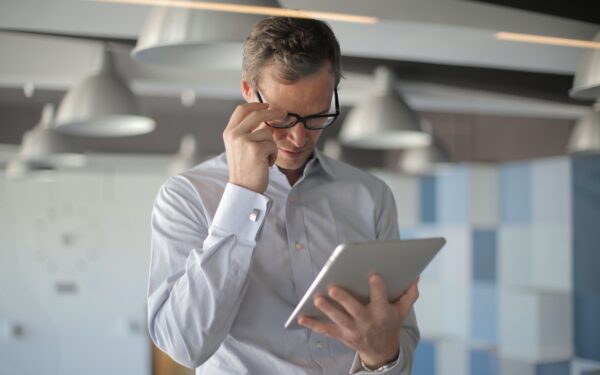 man-in-glasses-holding-ipad
