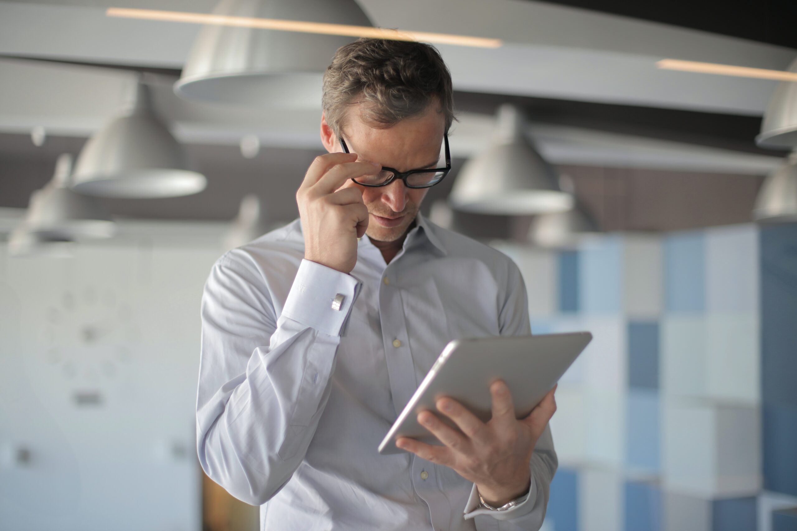 man-in-glasses-holding-ipad