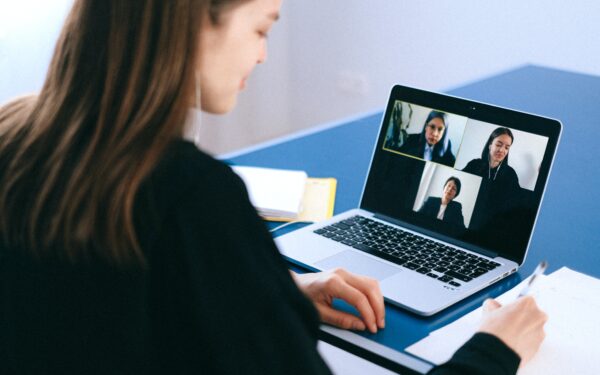 woman-sitting-at-desk-on-video-call-on-laptop