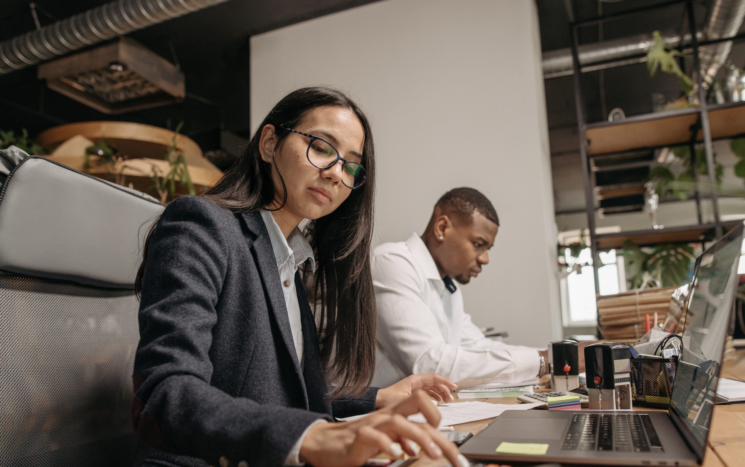 Man and woman working at desks on computers