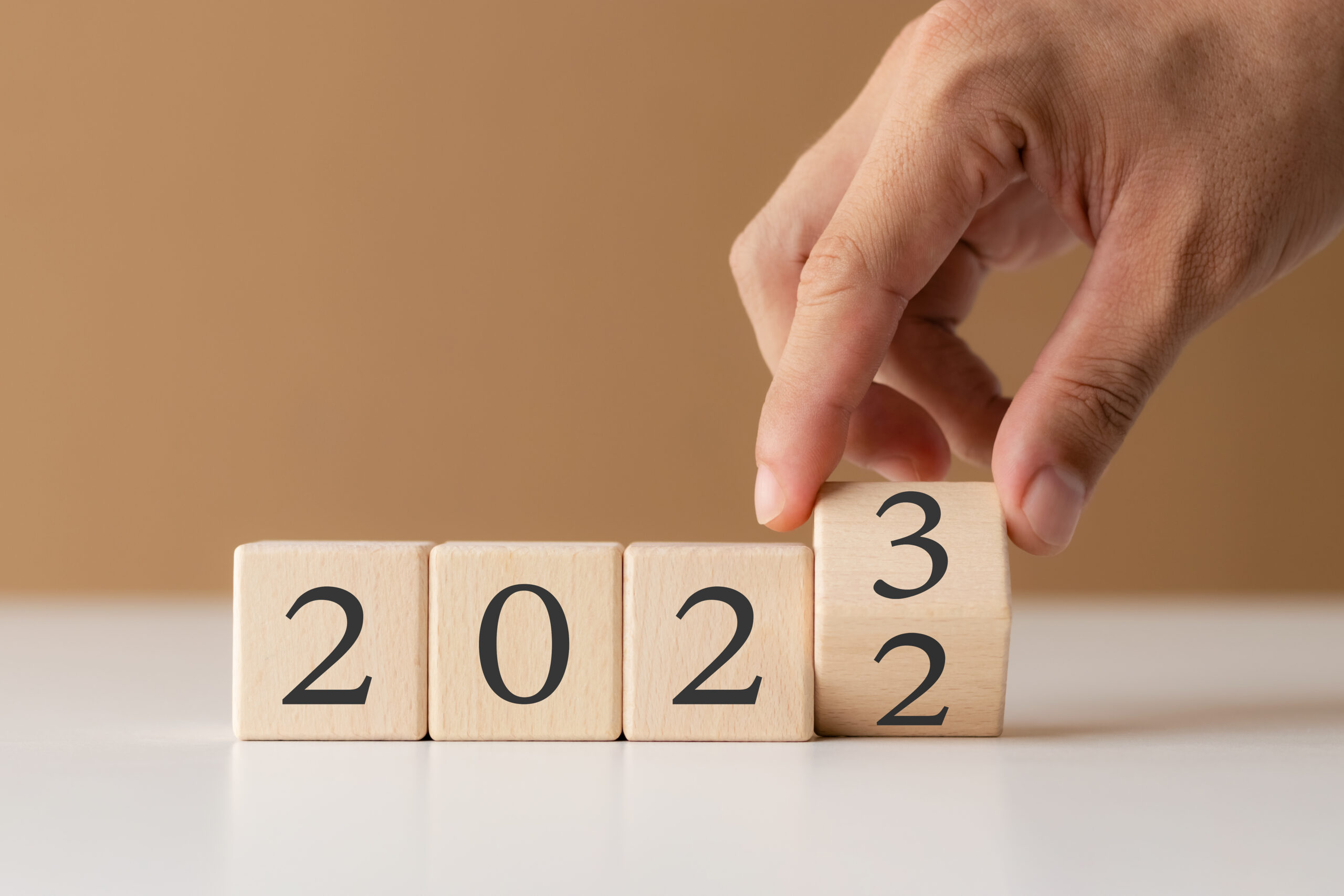 wooden cubes each with a number in 2023 on white table