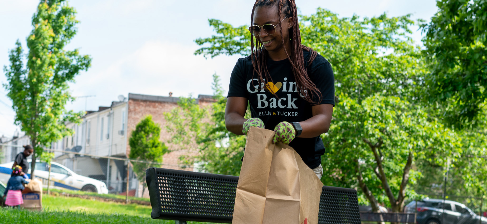 Ellin & Tucker employee volunteering cleaning up a city neighborhood