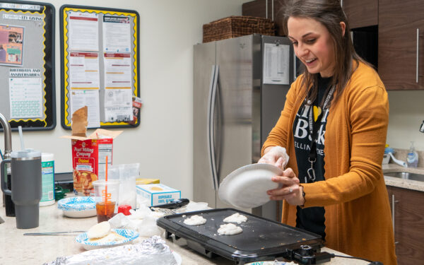 Grace Wickwire, Giving Back Committee chair, makes pancakes at the Ellin & Tucker office.